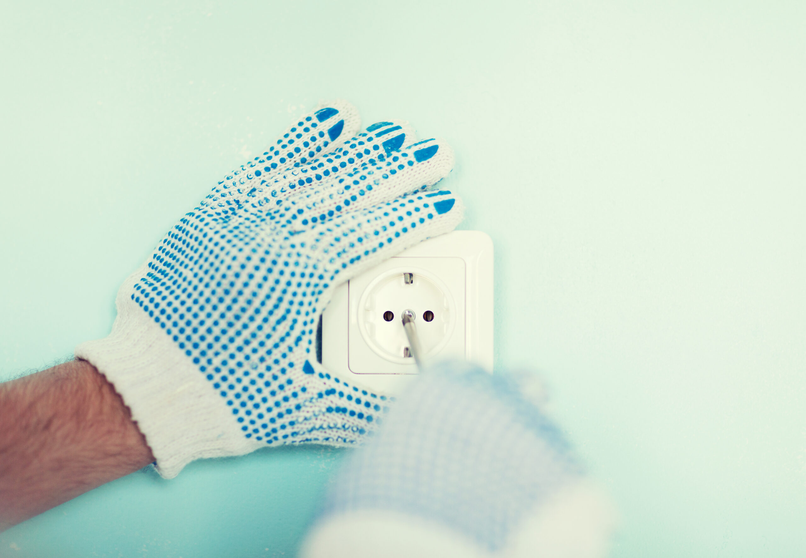 close up of male in gloves installing new socket